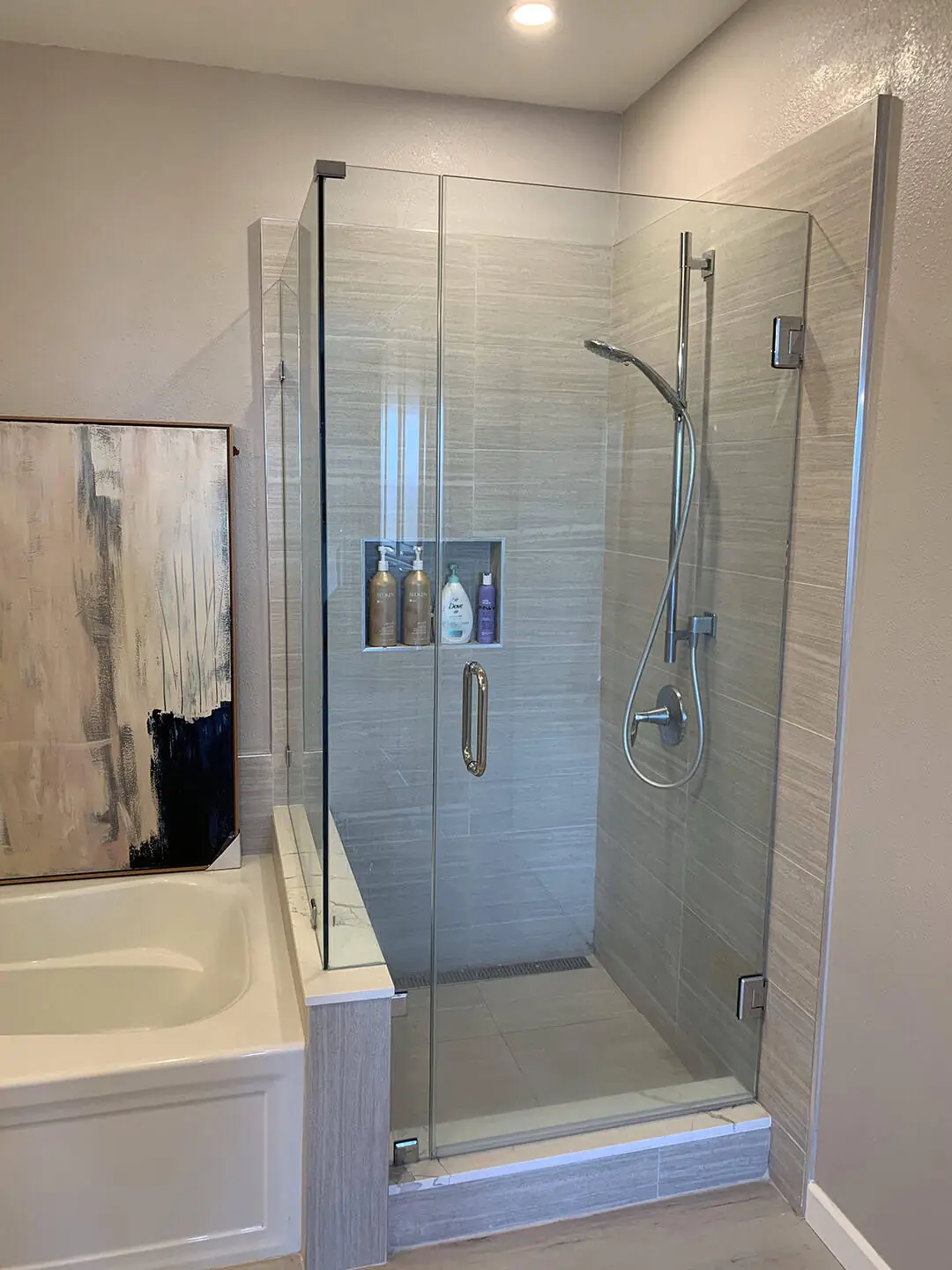 glass shower with tiled shelf