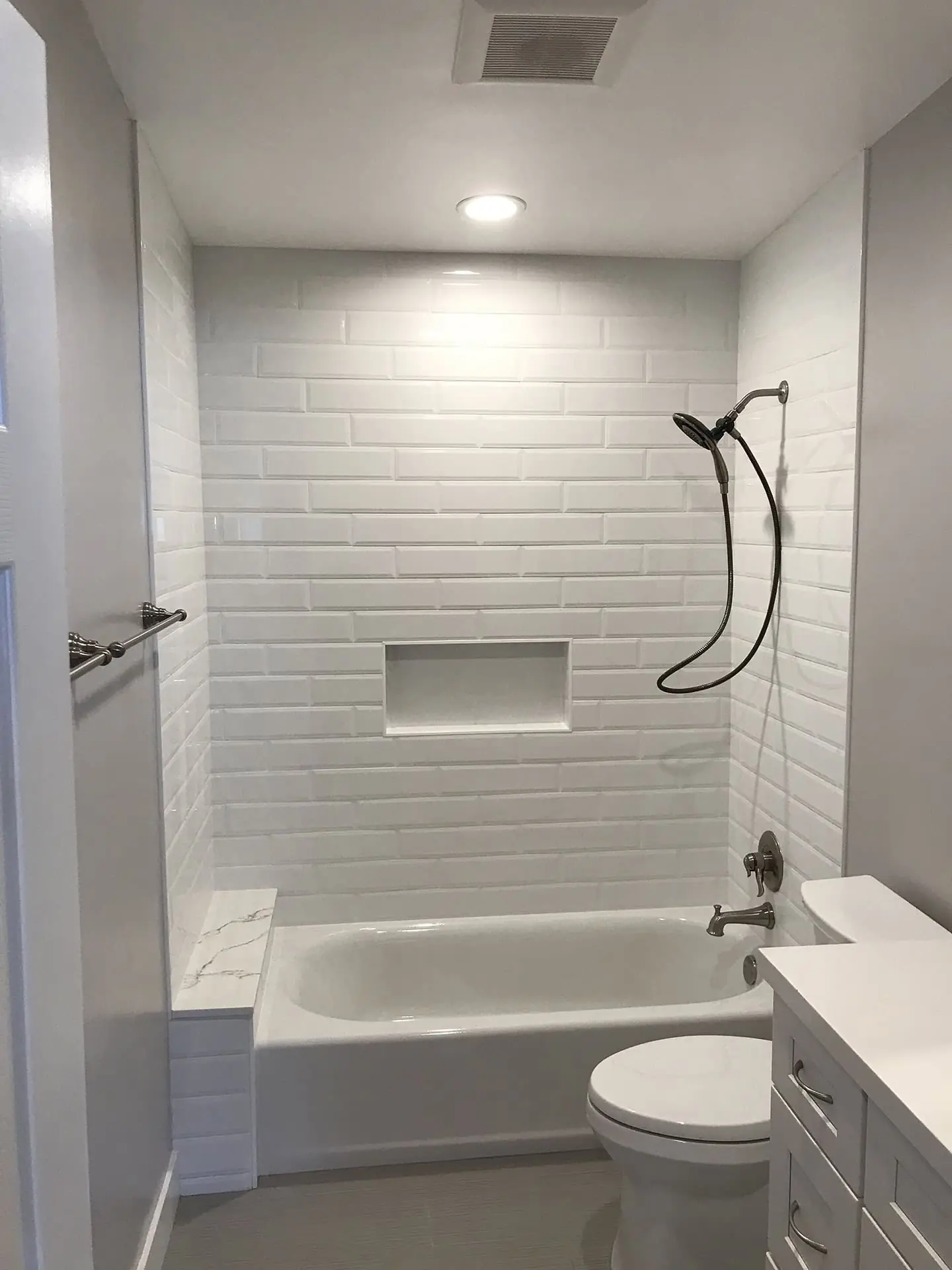 white bathroom with brick-effect wall