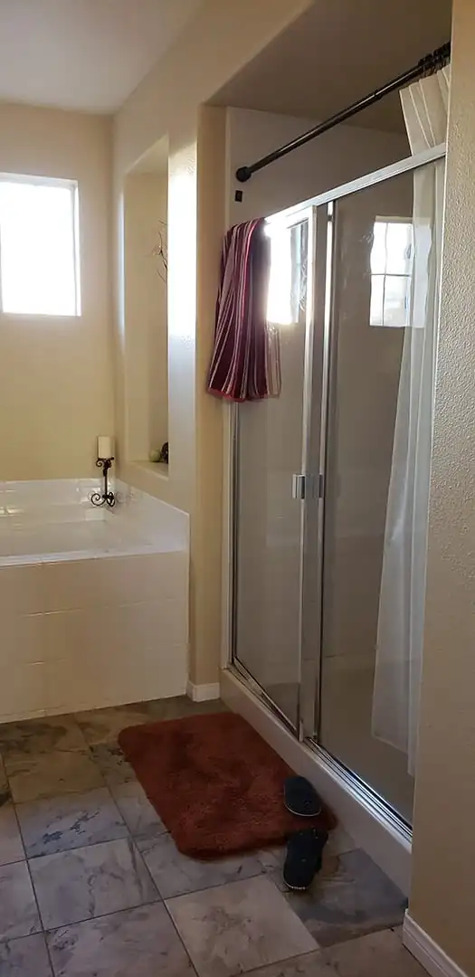 shower next to the bathtub