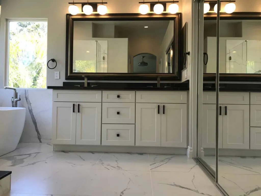 dresser in the bathroom with a large mirror
