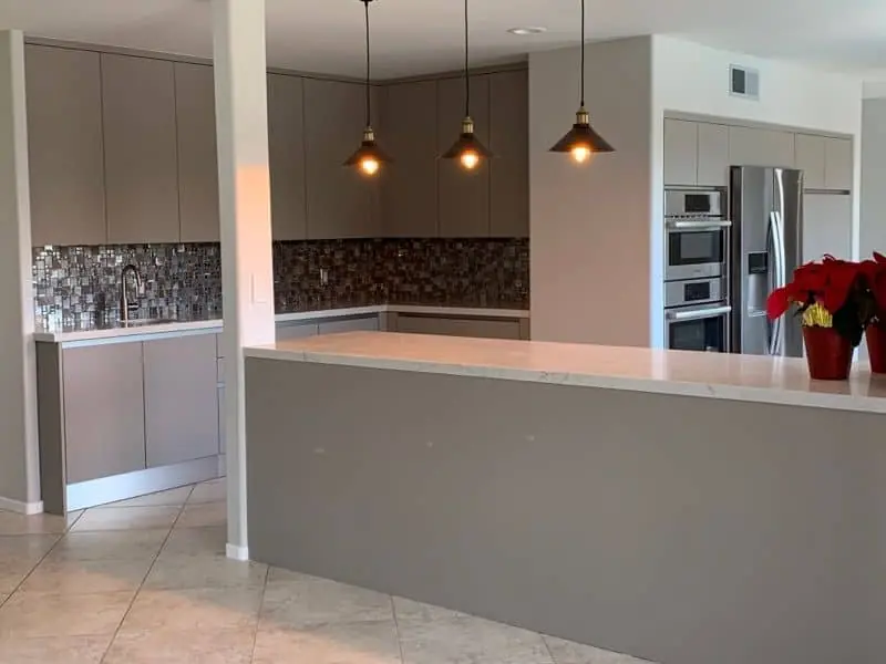 light gray kitchen with pendant lamps