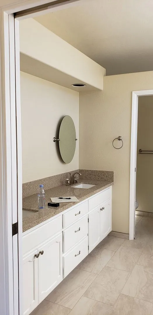 bright bathroom with a round mirror