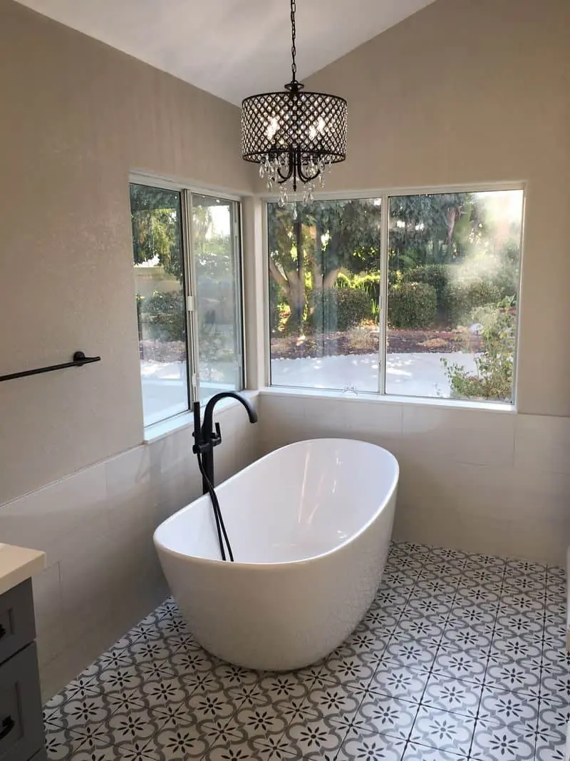 a round bathtub near a corner window