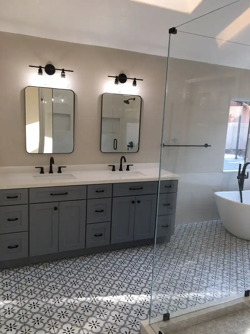 a double sink with gray backlit mirrors