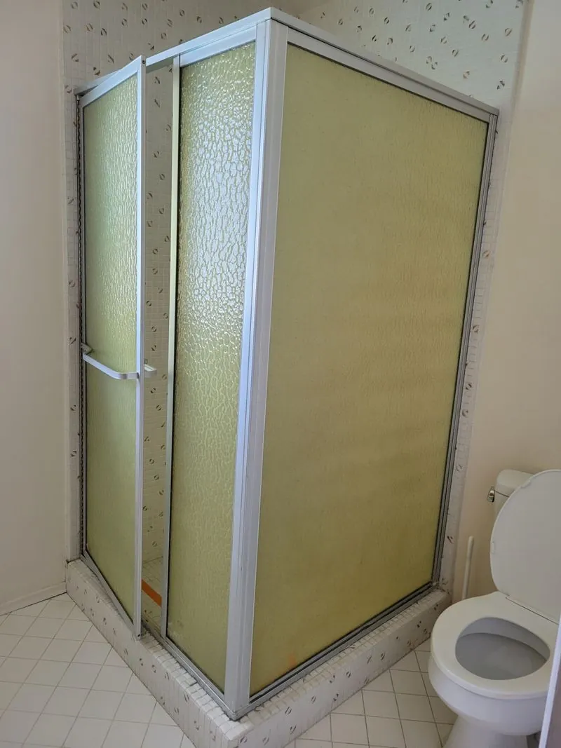 toilet next to the yellow shower