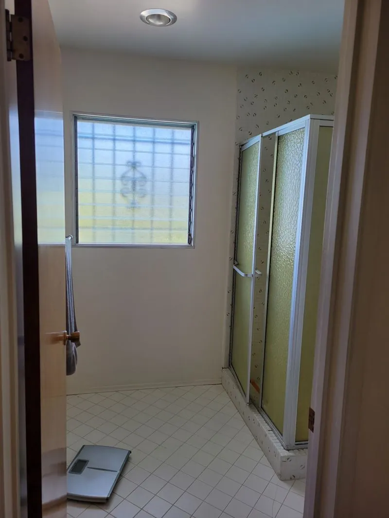 spacious bathroom with a yellow shower