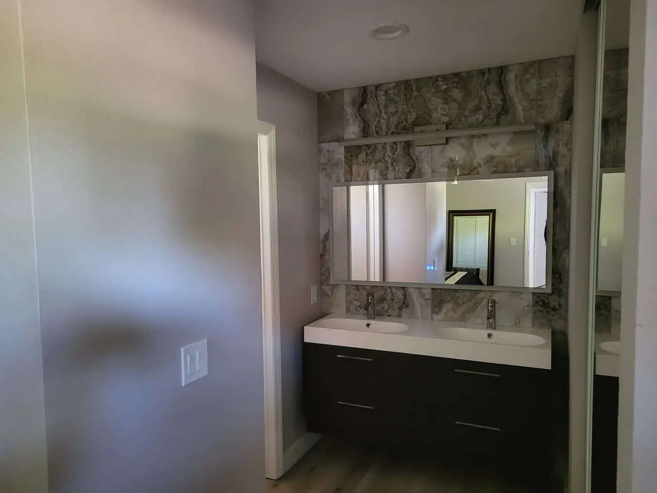 marble bathroom with dark wenge furniture