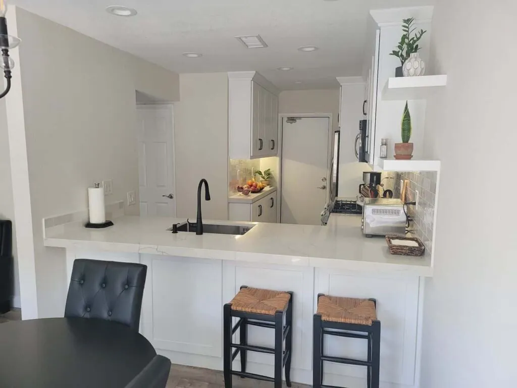 white kitchen with bar stools