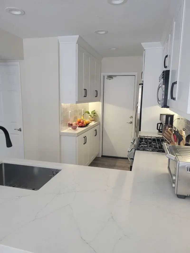 black faucet on a white kitchen