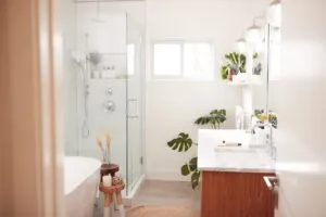 a light bathroom with warm wood elements