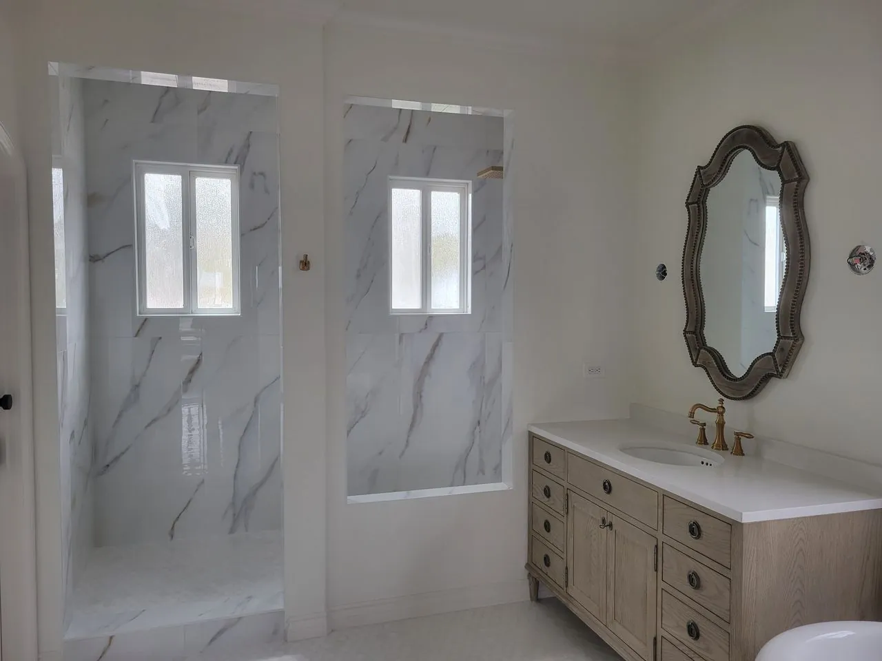 white bathroom with marble showers