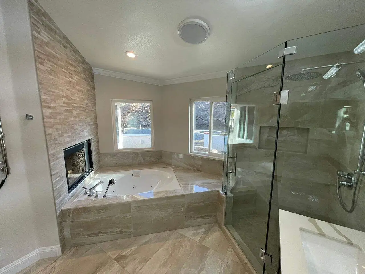 beige bathroom with a large bathtub