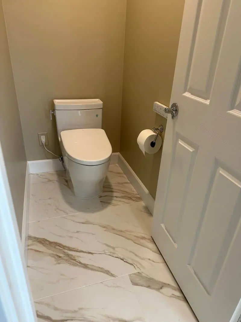 toilet with a marble floor