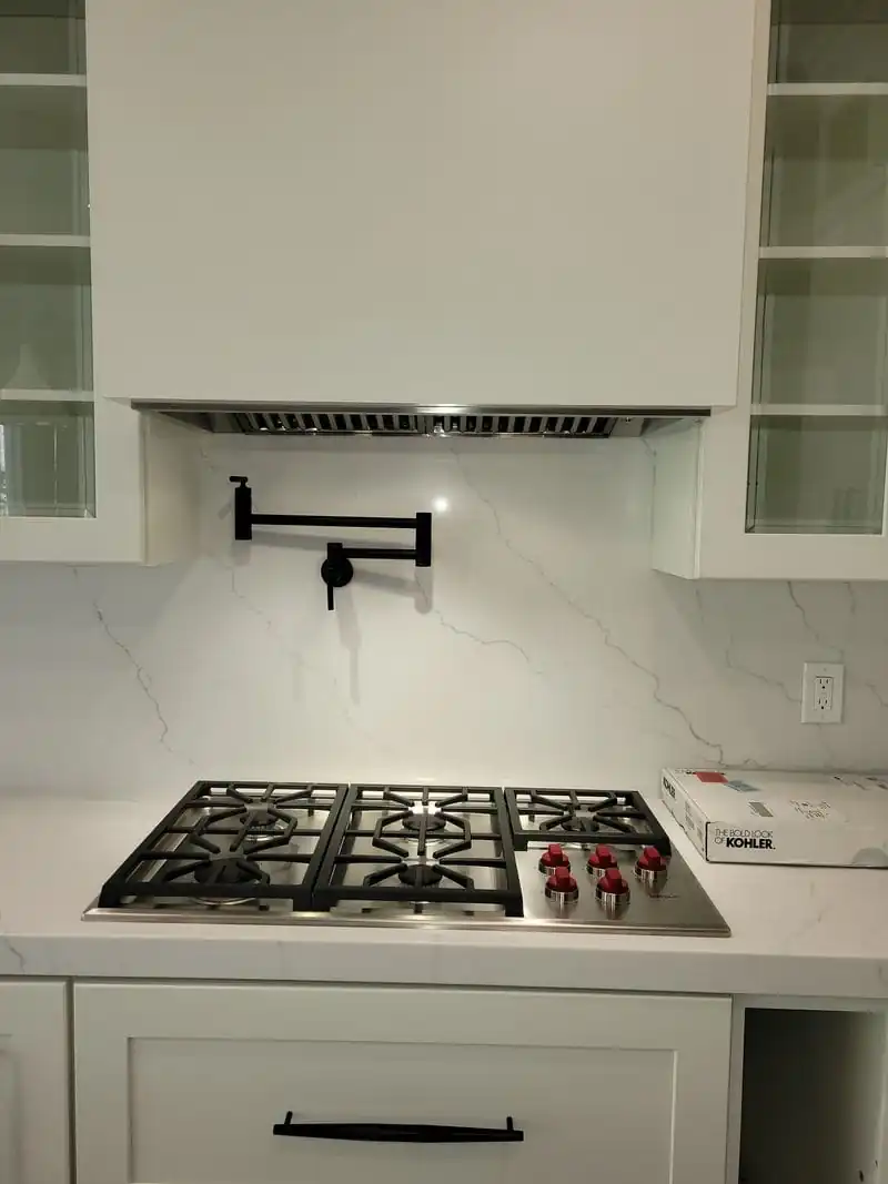 built-in range hood in a white kitchen