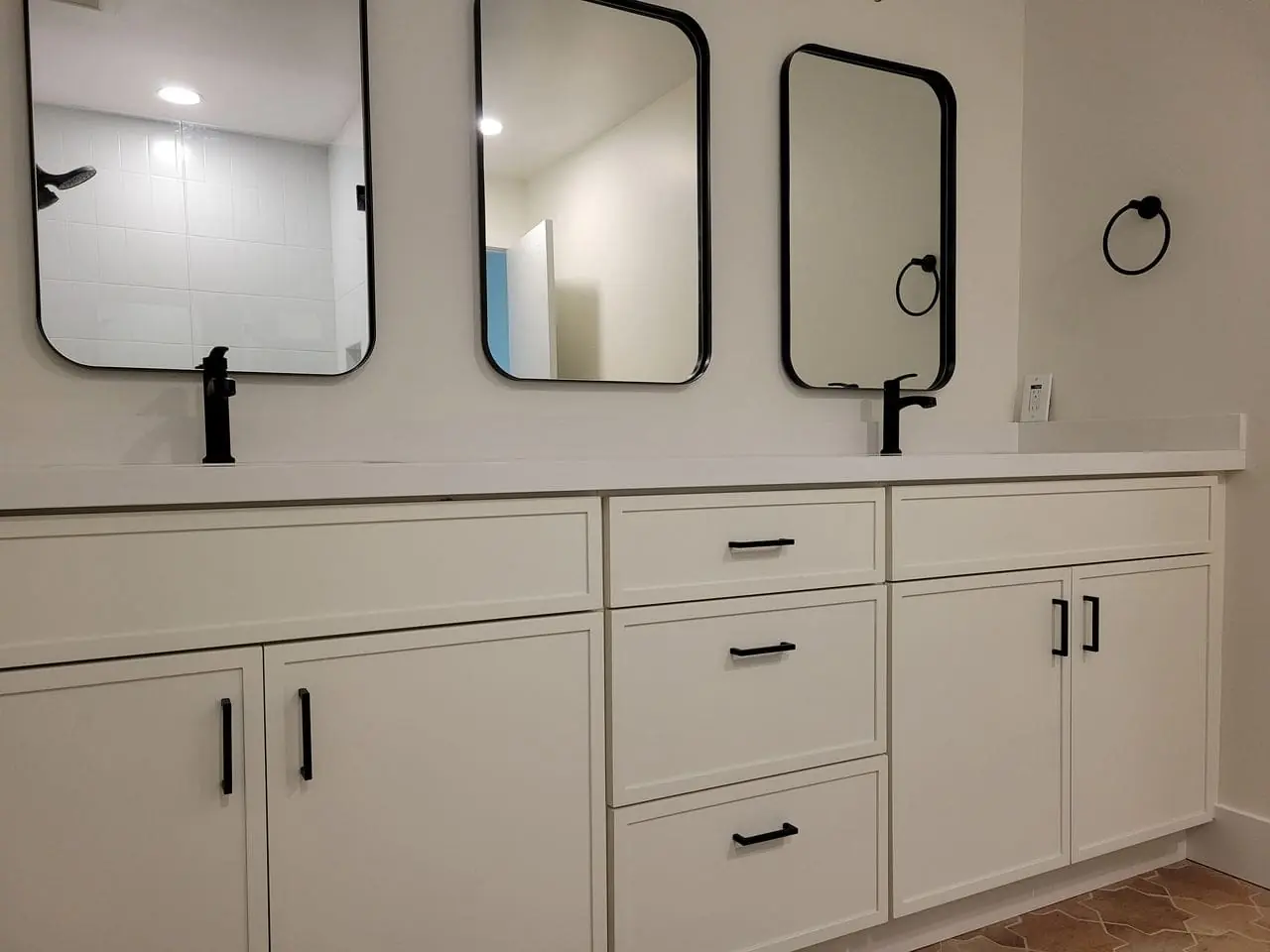 three mirrors in black frames