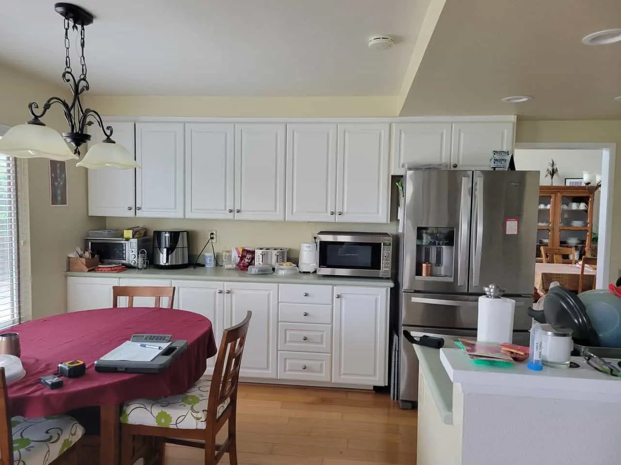 large gray refrigerator in a white kitchen
