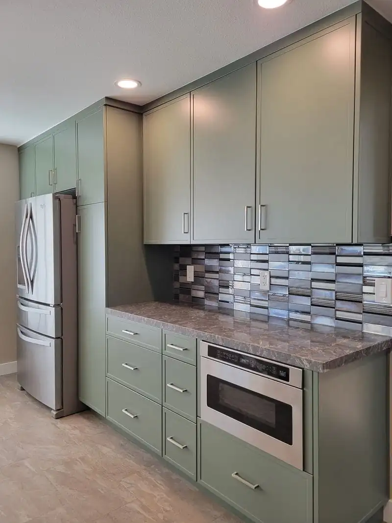 built-in refrigerator in an olive kitchen