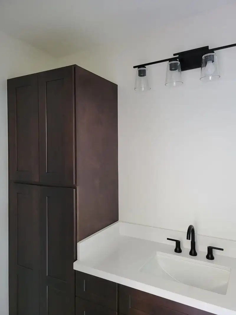 dark brown cabinet in the bathroom