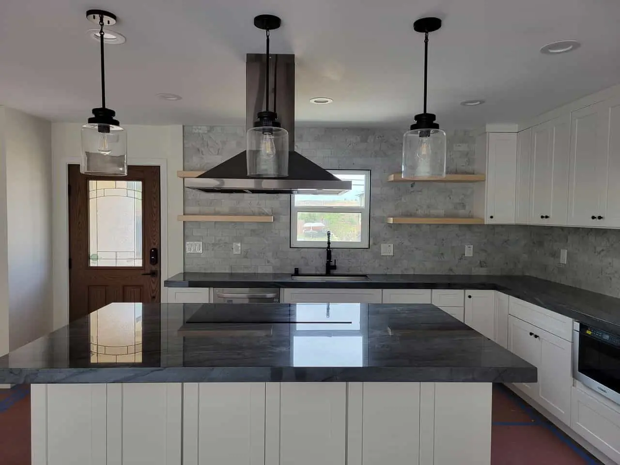 white kitchen with accent gray tiles