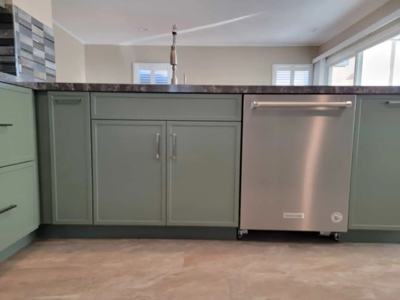gray dishwasher in an olive kitchen
